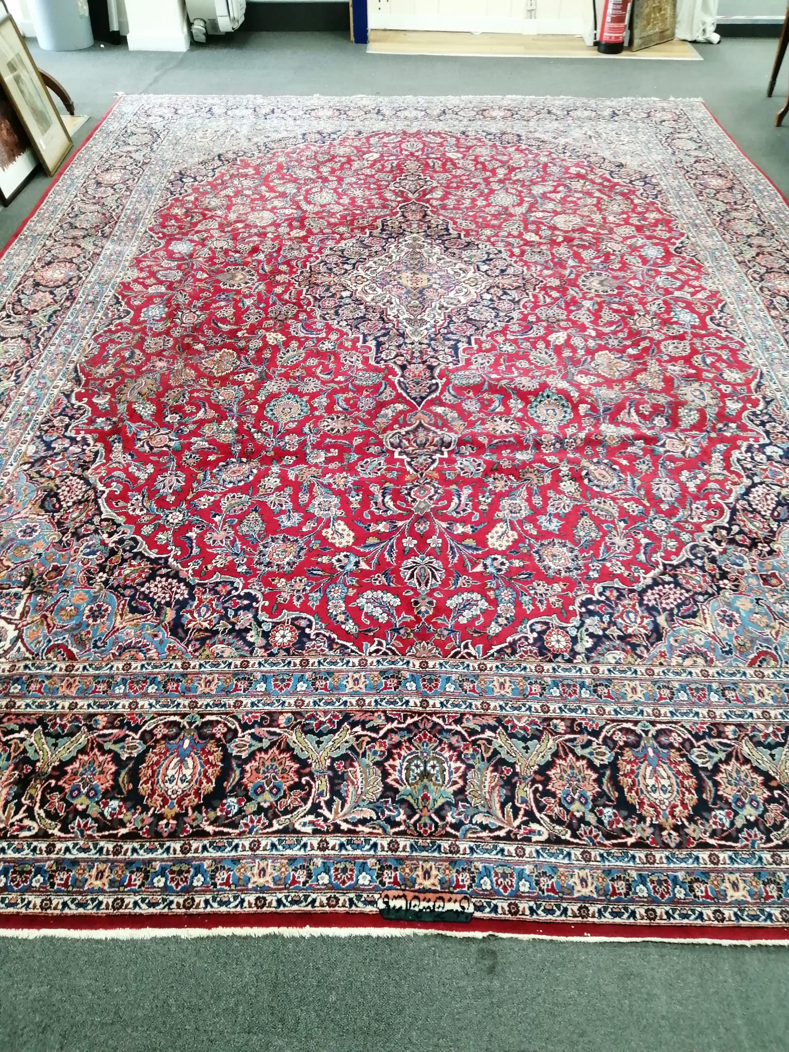 A Tabriz burgundy ground carpet, 460 x 330cm